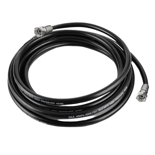 Coiled high-pressure hose with metal connectors on a white background